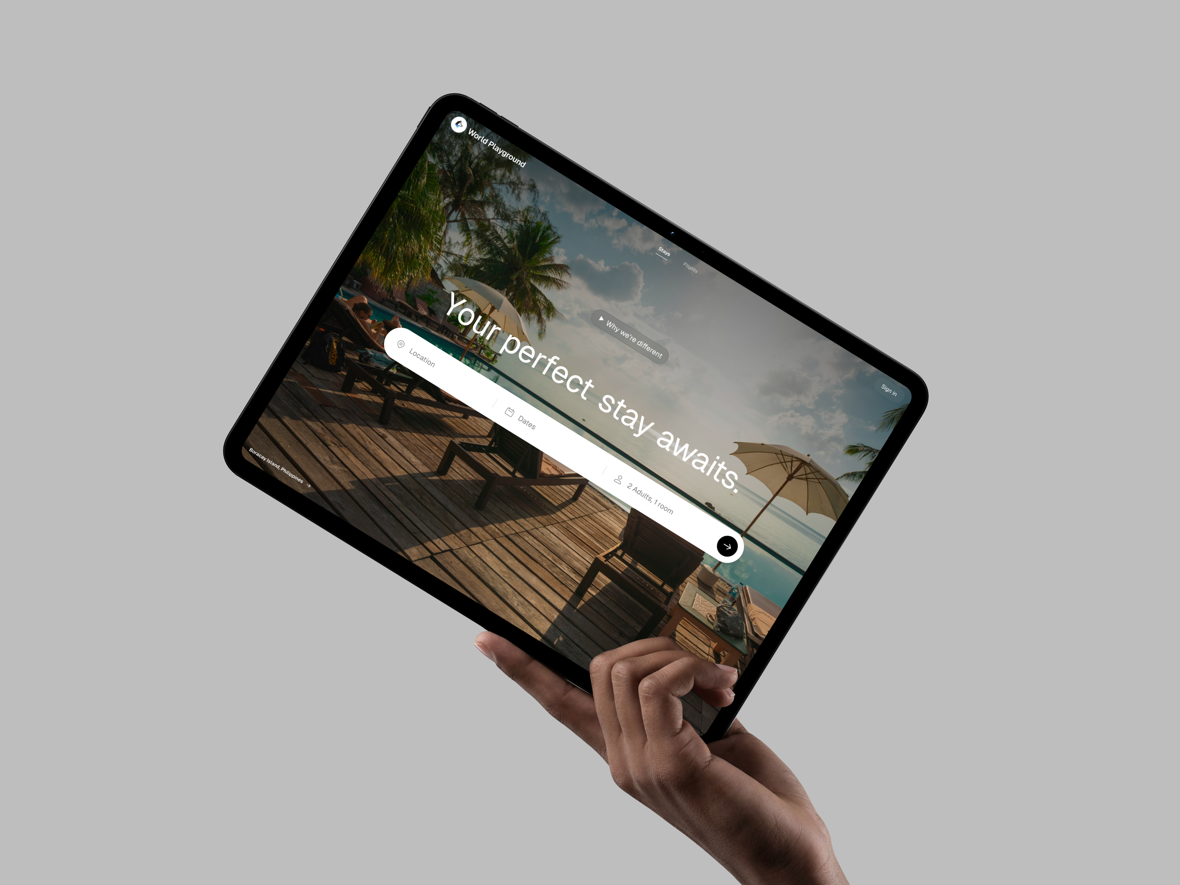 World Playground stay search displayed on a tilted tablet held by a hand